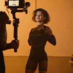 Female Fashion Model Posing in Front of a Movie Camera